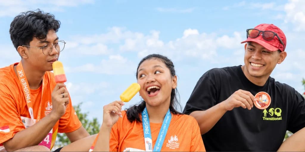 Runners celebrating with refreshing gelato sticks under the open sky