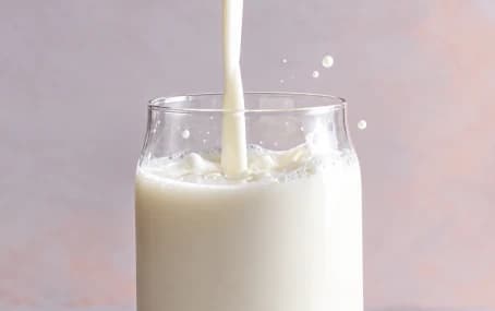Fresh milk pouring into a glass