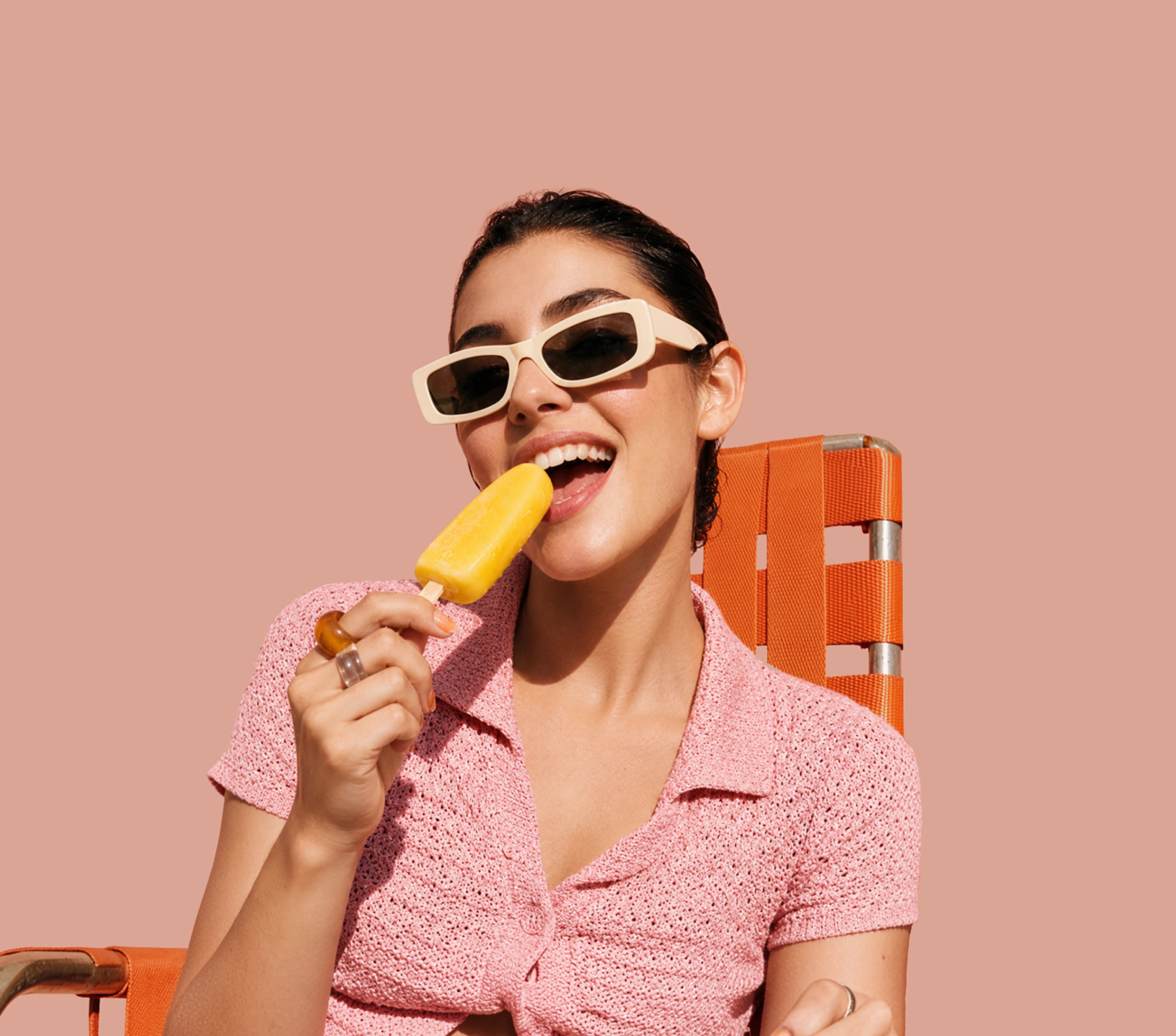 Woman enjoying a mango popsicle